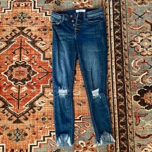 Medium wash blue KanCan skinny jeans with holes